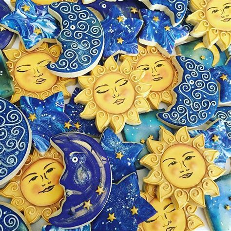 the sun and moon cookies are decorated with blue icing