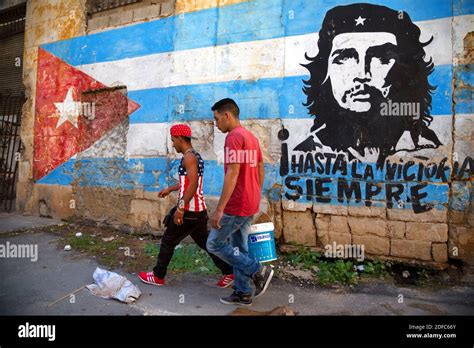 Cuba, man wearing shirt with American flag, communist painting by Hasta ...