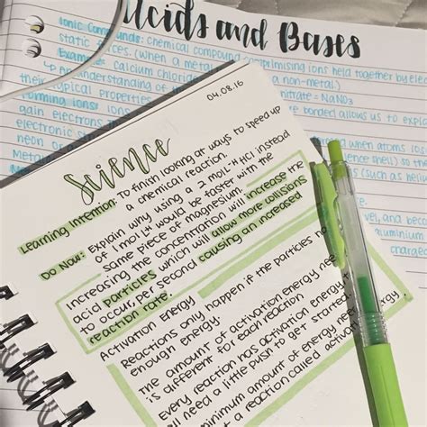 a green pen sitting on top of a paper next to a notebook with writing in it