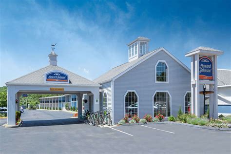 a white building with a bike parked in front of it next to a parking lot