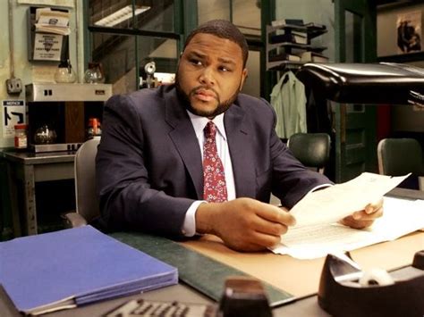 a man sitting at a desk with papers in front of him