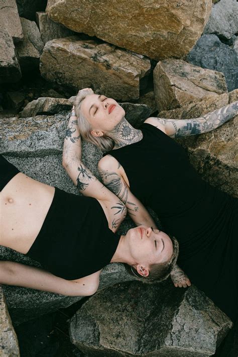 Women in Black Clothing Lying on Gray Rocks · Free Stock Photo