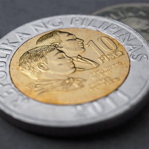 Philippine Coins Lie on a Dark Surface. Coin of 10 Philippine Pesos ...