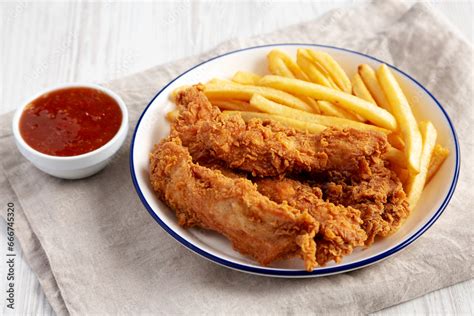 Crispy Chicken Strips with French Fries and Sour-Sweet Sauce Stock ...