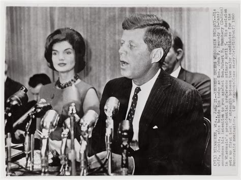 [Senator John F. Kennedy giving a speech with Jacqueline Kennedy in background, Milwaukee ...