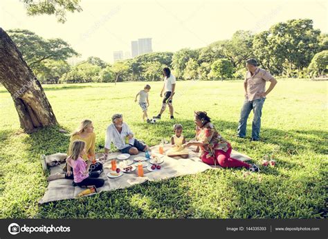 Family having picnic in park — Stock Photo © Rawpixel #144335393