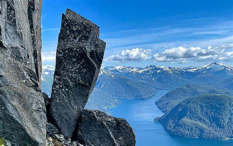 Precariously balanced boulder near the top of Mt. Verstovia, Sitka, Alaska, clouds, landscape ...