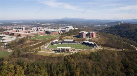 Aerial View Of A College Campus With A Football Field And Tree In The Background, Liberty ...