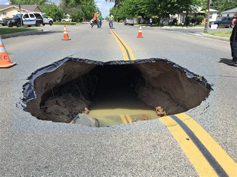 Video shows huge sinkhole open up on street in California | The Independent