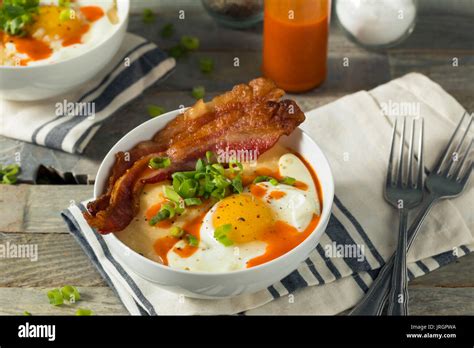 Homemade Cheesy Breakfast Grits with Eggs and Bacon Stock Photo - Alamy