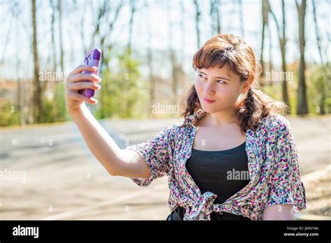 Young millennial woman taking a selfie with duck lips face Stock Photo ...