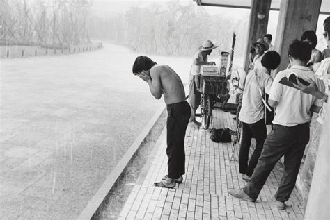 Ryoji Akiyama. Young Man Washing His Face in the Rain at the "Anti-War Exposition", Held Near ...