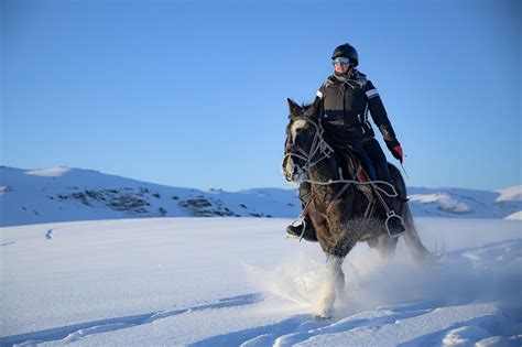 Man Horseback Riding on Snow Covered Ground · Free Stock Photo