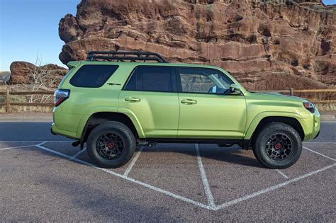 Download A Green Toyota 4runner Parked In A Parking Lot | Wallpapers.com