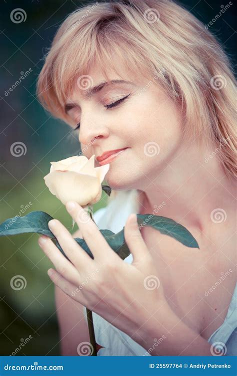 Smiling woman with flower stock photo. Image of rendezvous - 25597764