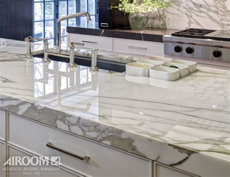 Contemporary and clean, a Calcutta Gold marble countertop lends flair to this modern Winnetka ...