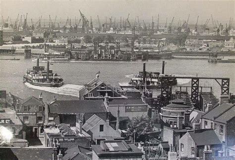 an old black and white photo of boats in the water next to buildings ...