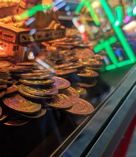 Coin pusher coin holding on for dear life : r/DaveAndBusters