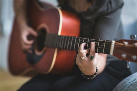 Grayscale Photography of Person Playing Yamaha Acoustic Guitar · Free Stock Photo