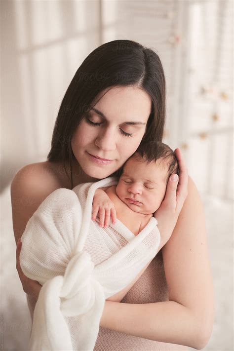 "Beautiful Mother Holding Her Newborn Baby Tight" by Stocksy ...