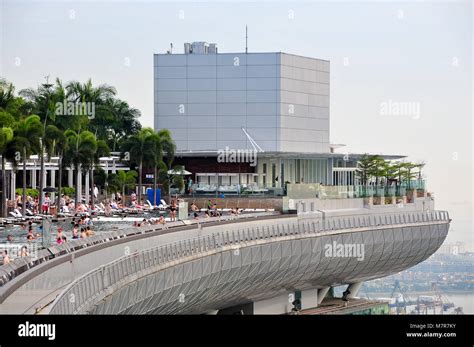 Rooftop infinity pool at the Marina Bay Sands Skypark, in Singapore showing people relaxing to ...