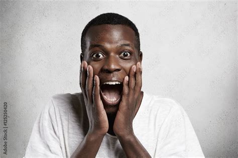 African employee or customer with shocked and surprised face, looking ...