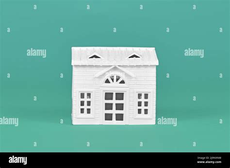 Simple white house model on teal background Stock Photo - Alamy