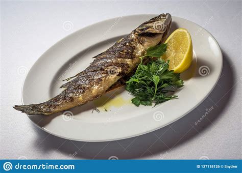 Sea Bass with Lemon and Herbs Stock Photo - Image of dinner, table ...