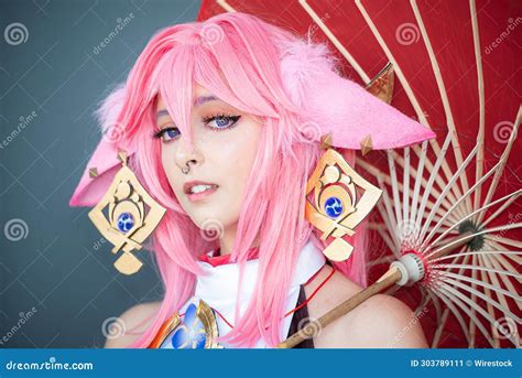 Female Cosplayer in a Pink Anime Costume Wearing Pink Hair Stock Image - Image of victorious ...