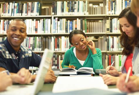 Group of college students studying in library - Family Service of Roanoke Valley