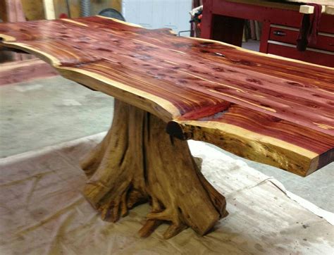 a large wooden table sitting on top of a piece of wood in a room filled with furniture