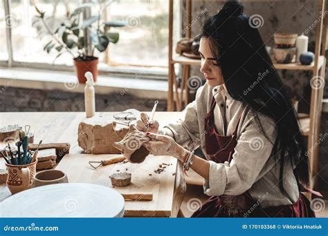 Craftsperson Concept. Young Woman Making Pottery Indoors Making Shape for Clay Using Tool ...