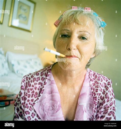 Senior woman smoking cigarette, portrait Stock Photo - Alamy