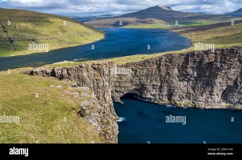 Iconic lake and ocean cliffs in Faroe Islands Stock Photo - Alamy