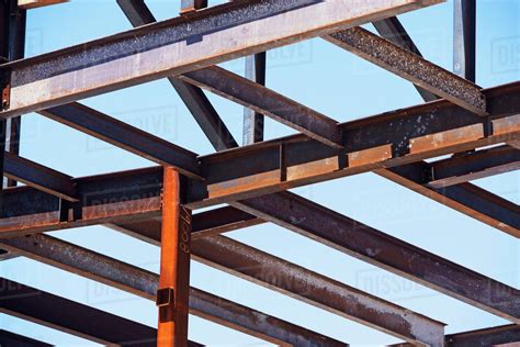 Low angle view of steel beams at construction site - Stock Photo - Dissolve