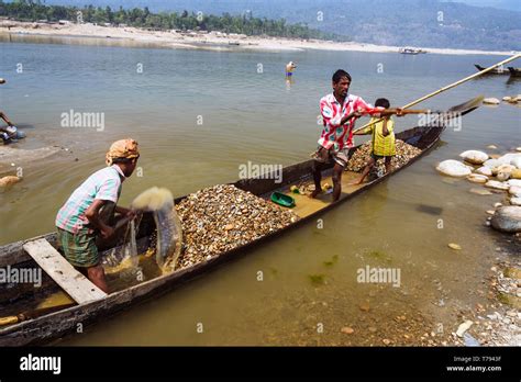 Jaflong, Sylhet, Bangladesh : Mari River. Bangladeshi family on a small ...