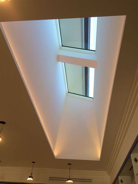 Skylight and light well with LED strips hidden along the two long edges. Looks like soft light ...