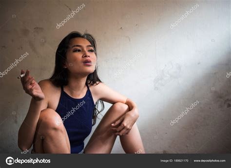 Stress woman smoking cigarette in room — Stock Photo © blanscape #189921170