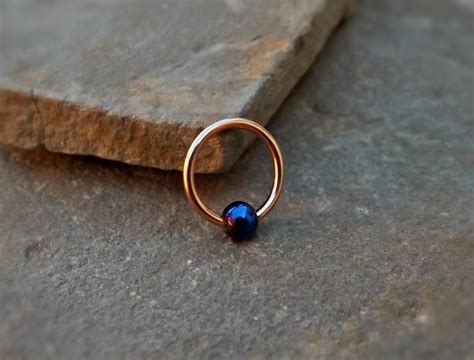 This beautiful hoop is accent by a blue bead enclosure. It is a 3/8" 16ga hoop… Morganite ...