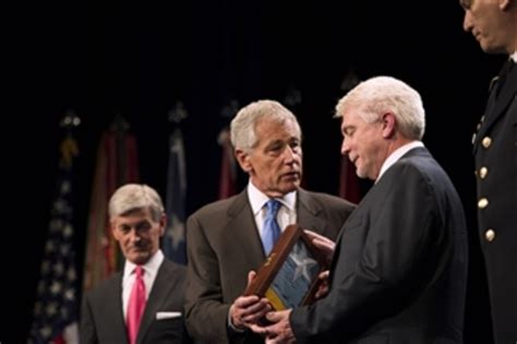 Secretary Hagel presents the Medal of Honor flag to Ray Kapaun