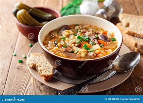 Traditional Russian Soup Rassolnik with Pickled Cucumbers and Pearl Barley in Bowl on Wooden ...