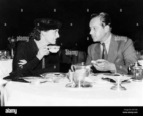 Melvyn Douglas, right, and his wife, Helen Gahagan Douglas, having tea in Washington, D.C ...