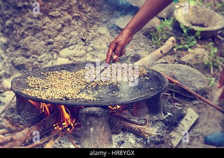 A roasting pan with coffee beans, roasted in Ethiopia tradition way, at firewood Stock Photo - Alamy