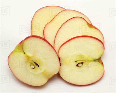 Pink Lady apple, sliced - Stock Photo - Dissolve