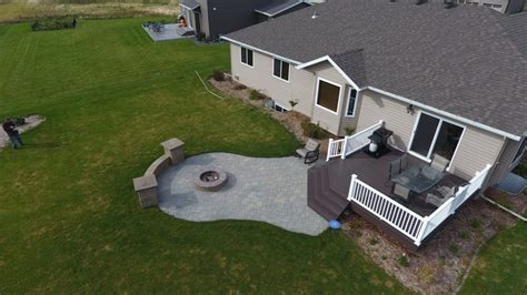 Raised Deck to Patio with Fire Pit and Seat Wall in West Fargo, ND - Oasis Landscapes