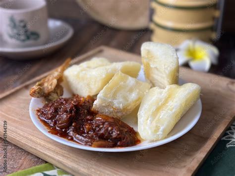 Ubi rebus or steam cassava is traditional malay dish. Serve with fried ...