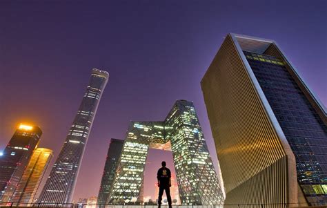 Man Standing Across Buildings · Free Stock Photo