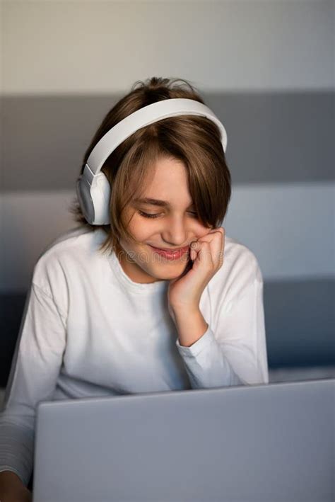 Smiling Teenager Boy Looking at Laptop Screen, Communicates Online or ...