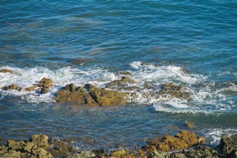 Rocks in sea tide waves stock photo. Image of granit - 93529442