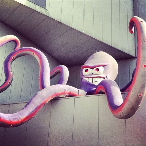 an octopus sculpture hanging from the side of a building